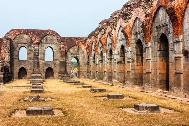 The beautiful ruins columns of the Baro Shona mosque in Gaur Malda, West Bengal, India - January 2018: The ruins of a broken hall with stone arches at the ancient Baro Shona Masjid in the village of Gour. gaur stock pictures, royalty-free photos & images