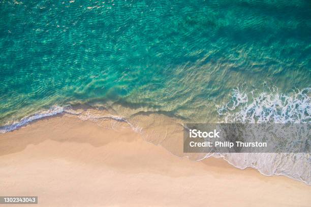 Clean Ocean Waves Breaking On White Sand Beach With Turquoise Emerald Coloured Water Stock Photo - Download Image Now