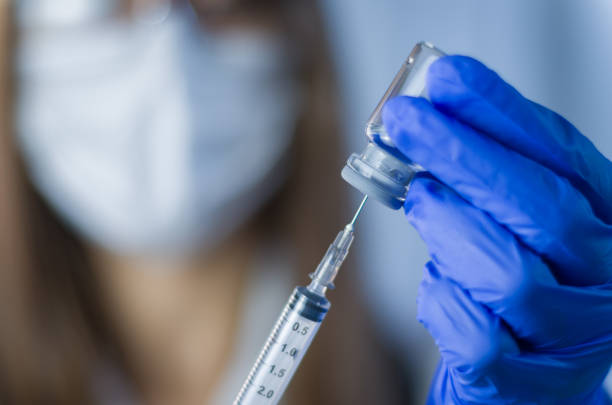 Vaccine in researcher hands Vaccine in researcher hands, female doctor holds syringe and bottle with vaccine for coronavirus cure. Concept of corona virus treatment, injection, shot and clinical trial during pandemic. vaccination stock pictures, royalty-free photos & images