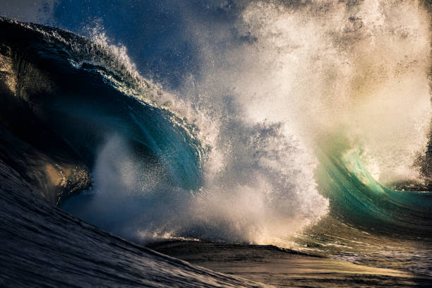 istock Powerful ocean surf colliding in golden light 1302343973