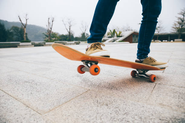 istock Skateboarder skateboarding outdoors on sunny morning 1302348909