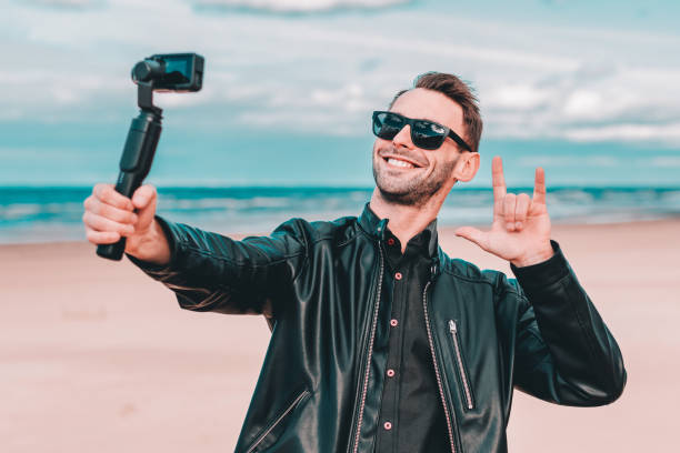 istock Handsome Guy Making Selfie at the Beach 1302350757