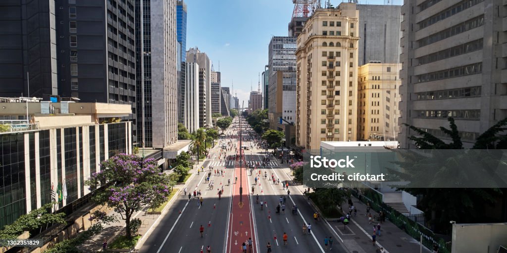 Paulista Avenue in Sao Paulo city. People walking on Avenida Paulista  in Sao Paulo city on sunny weekend. Avenue Stock Photo