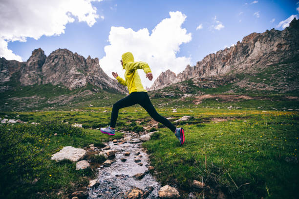 istock Woman trail runner running in wild mountains 1302353484