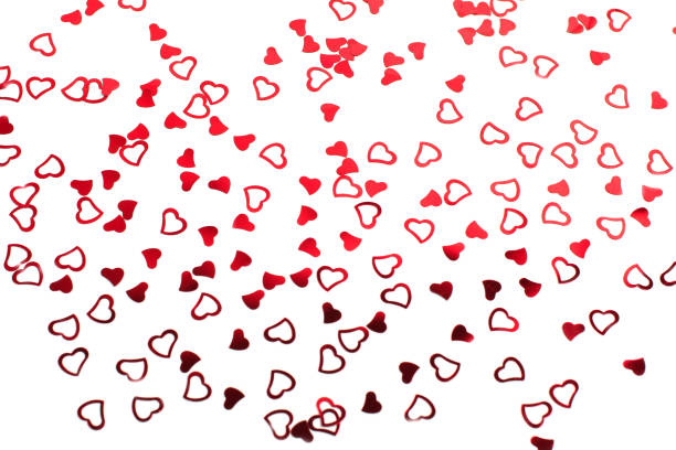 Valentine's day decorative pattern red hearts confetti on white background.