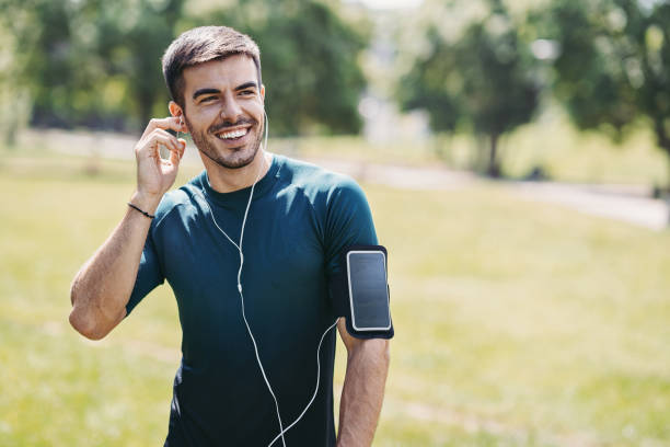 istock Smiling sportsman training in the park 1302354399