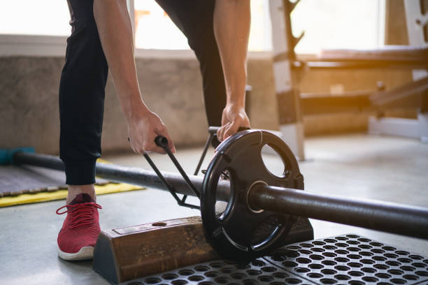 istock sport man exercise workout with dumbbell in the gym 1302358175