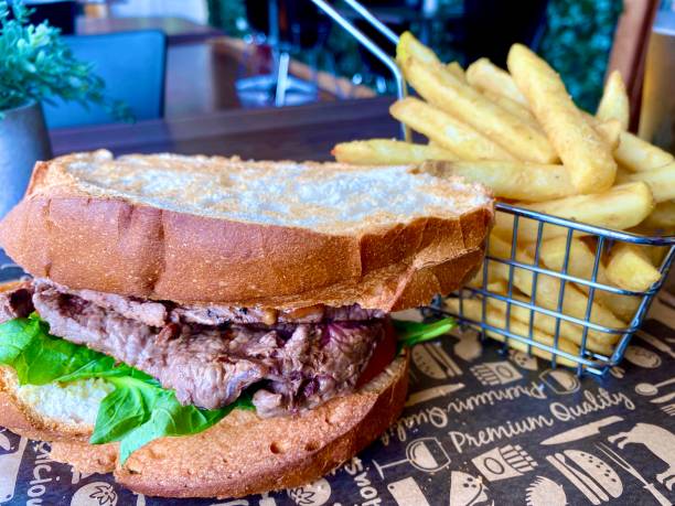 istock Steak Sandwich and Basket of Chips 1302358283