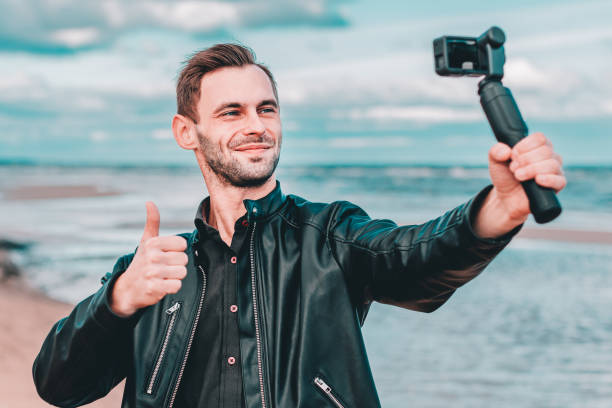 istock Handsome Guy Making Selfie at the Beach 1302360074