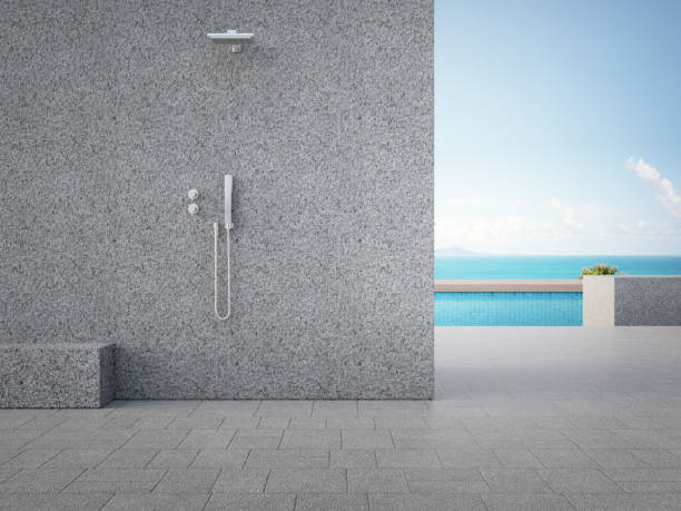 Gray concrete wall with outdoor shower.