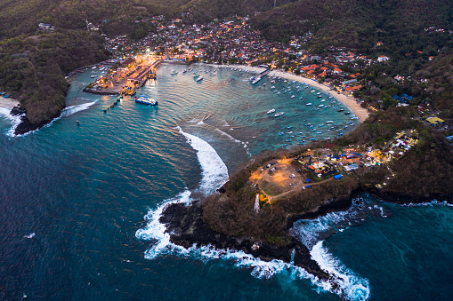 Aerial view of Padang Bai beach and harbor at nightfall in Bali in Indonesia, Southeast Asia