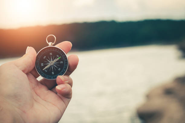 istock Compass of tourists on mountain at sunset sky. 1302367257