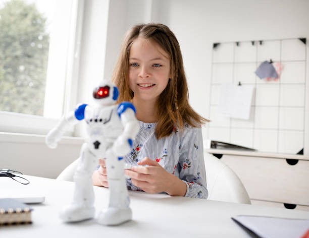 young, blond schoolgirl is playing with her robot toy