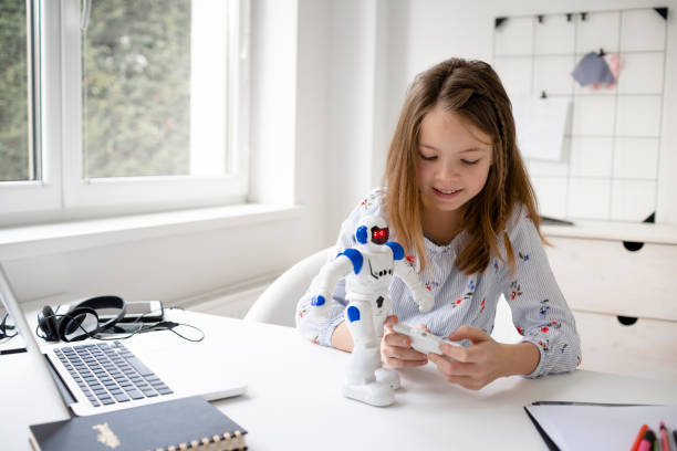 istock young, blond schoolgirl is playing with her robot toy 1302372505
