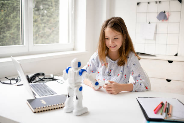istock young, blond schoolgirl is playing with her robot toy 1302373022