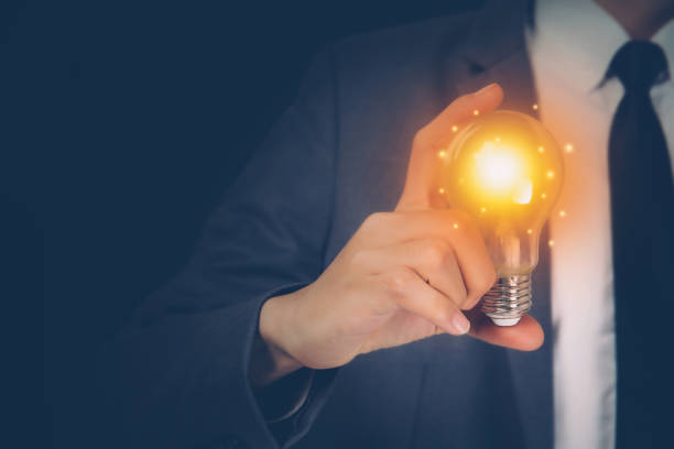 istock Businessman holding light bulb, imagination and intelligence, innovation and inspiration, brain symbol and solution and knowledge, creative idea and success, business and marketing concept. 1302373050