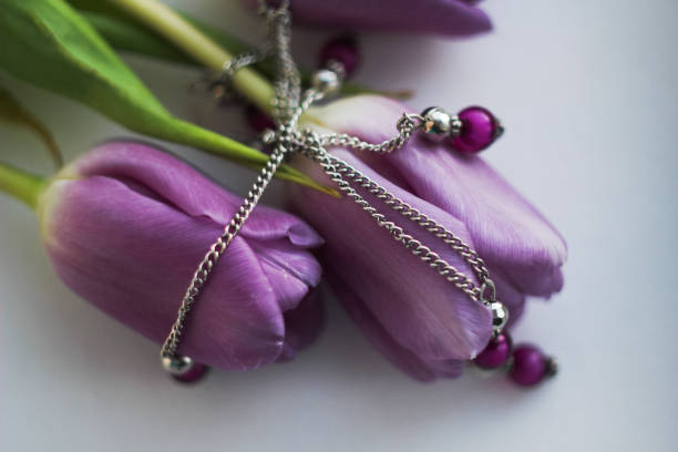 beautiful bouquet of tulips on a light background, jewelry accessories, a gift for Valentine's day, international women's day, a sign of attention, delicate bouquet, flower buds, lilac, purple flowers