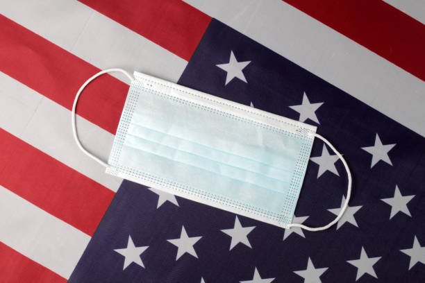 istock Medical mask on the usa flag 1302374082