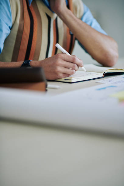 istock Businessman filling planner 1302374891