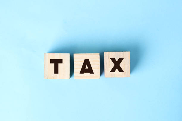istock Cubes with word TAX and nature. Distant work business concept 1302379352