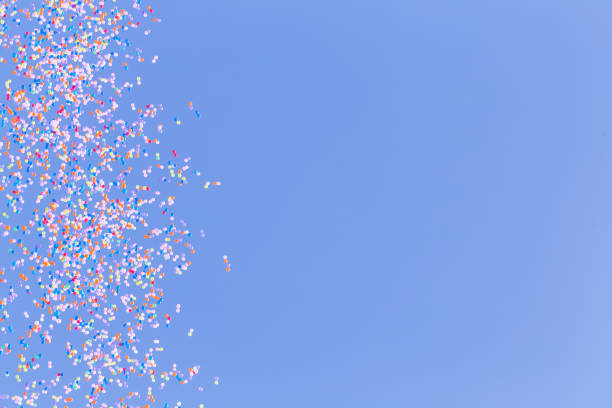 istock many colorful balloon flying in blue sky 1302381033