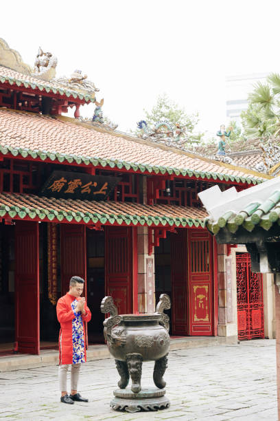 istock Man praying at bronze urn 1302382441