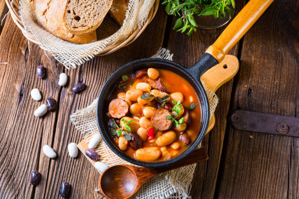 istock Delicious bean stew with sausage and potato 1302383449