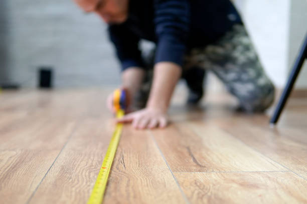 worker guy measures the length of the room. Focus on the ruler. The man is out of focus. The worker guy measures the length of the room. Focus on the ruler. The man is out of focus. measuring a room stock pictures, royalty-free photos & images