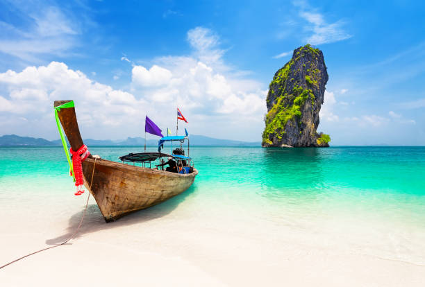 Thai longtail boat near Koh Poda island Thai traditional wooden longtail boat and beautiful sand beach at Koh Poda island in Krabi province. Ao Nang, Thailand. koh poda stock pictures, royalty-free photos & images