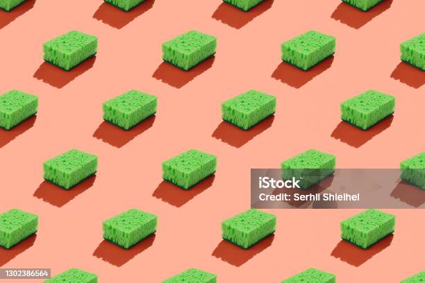 Green Washing Sponge Isolated On Red Background Seamless Pattern Stock Photo - Download Image Now