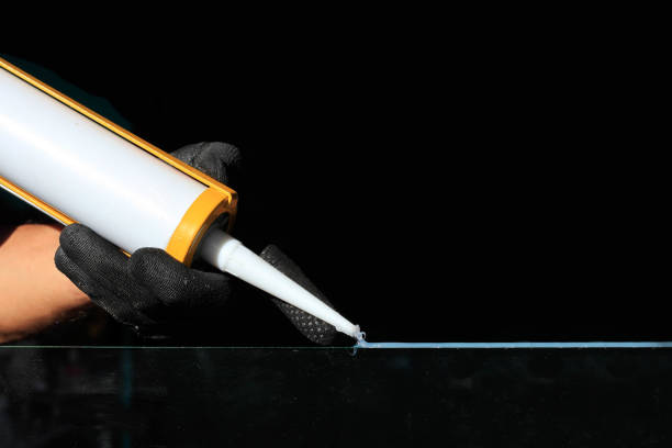 istock Craftsmen are using silicone adhesives for general and industrial applications 1302389085