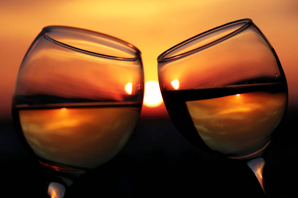 Couple clink glasses, concept of celebration, romantic evening, love date