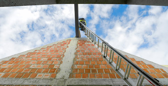 Unrecognizable worker working as a window cleaner on a modern high rise building.