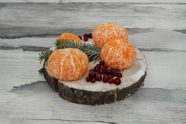 istock Tangerines with cranberries on rustic wooden background 1302394548