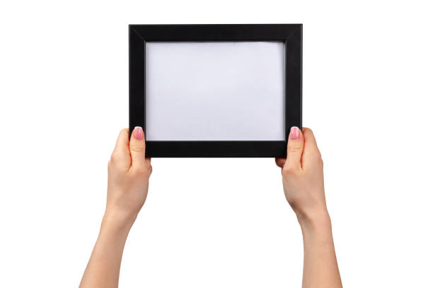 istock Female hands holding photo frame isolated on white 1302395092