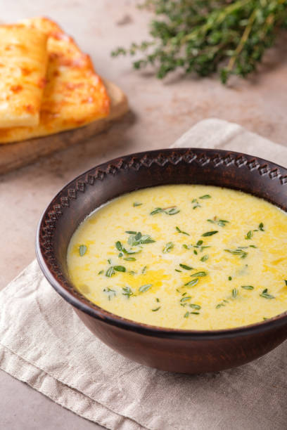 istock Cheese soup with thyme on a beige background. 1302398099