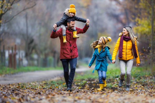 istock Happy family having fun while running in autumn day. 1302399785