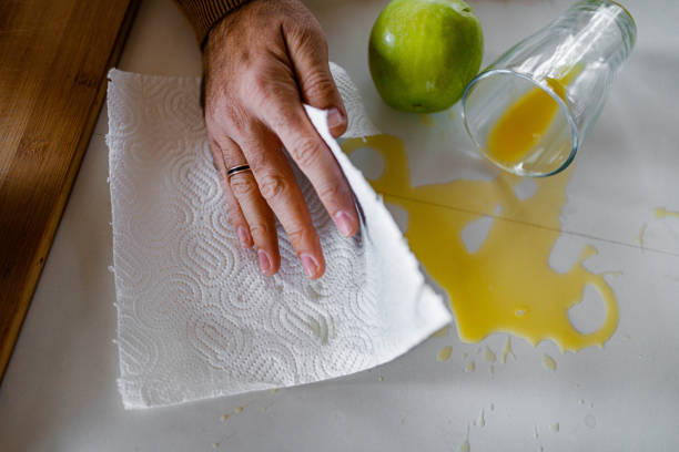 istock Cleaning spilled orange juice! 1302400037