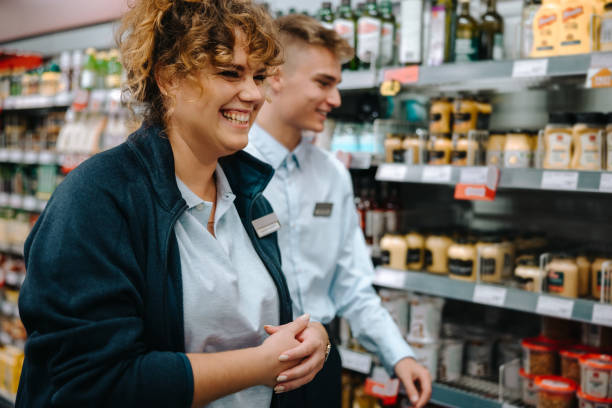 istock Supermarket manager with new employee 1302400301
