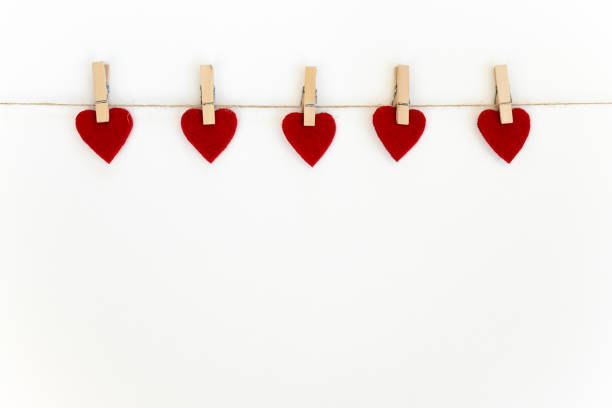 istock Valentine's day card. White background with red hearts on clothespins. 1302400516