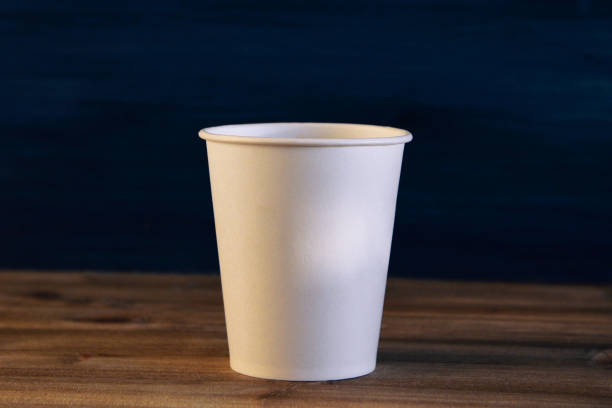 istock white empty cardboard Cup on wooden background 1302402133