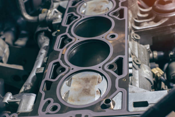 istock Auto mechanic working on car engine in mechanics garage. the cylinder block. 1302402204