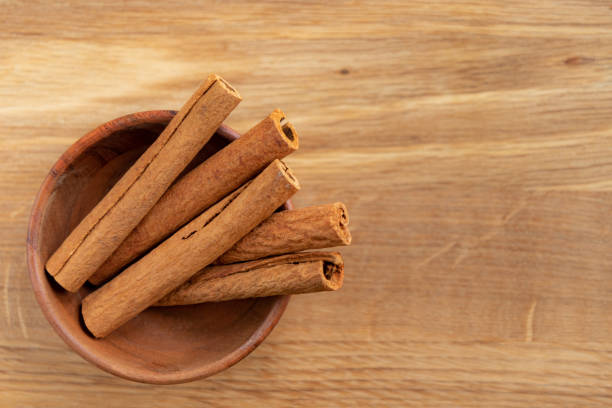 istock Cinnamon sticks in a wooden bowl. 1302403956