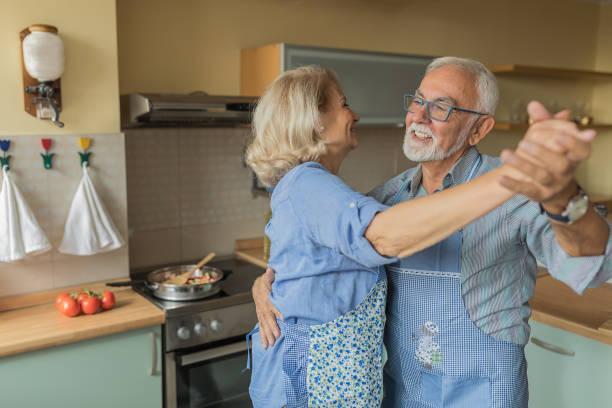 istock Happy Older Man and his Wife are Spending a Nice Time While Enjoying in Dinner Preparation at Home. 1302404517