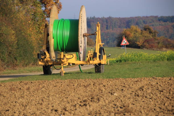 istock Trailer with a roller empty pipe for laying pipes in the ground 1302404756
