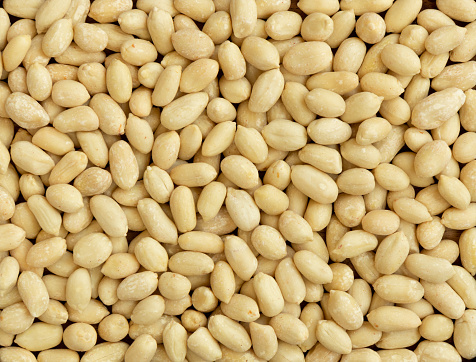 Top view of peeled peanuts as background, texture. Close-up of peanuts that peeled and ready to eat.