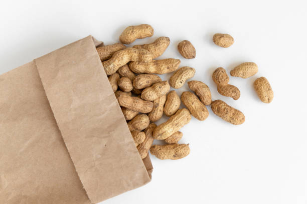 Peanuts and paper bag on the white background.