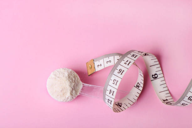 istock White protein powder in spoon and measuring tape 1302405953