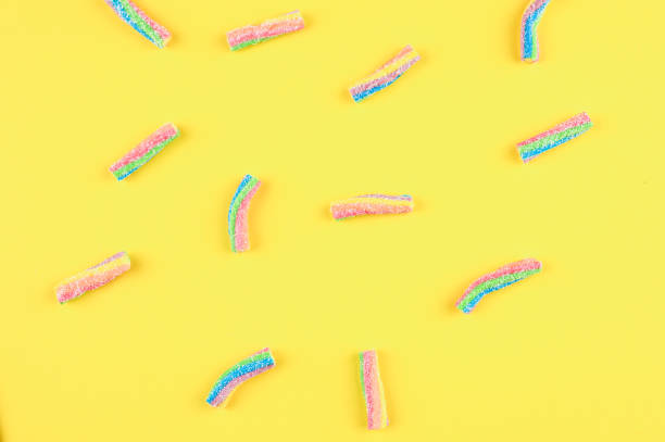 istock Rainbow jelly candies on a yellow background. 1302411055