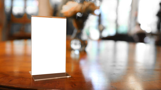 istock cafe menu. Menu frame standing on wood table in Bar restaurant cafe. space for text marketing promotion 1302412072